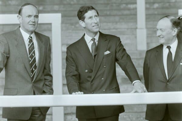 The Prince of Wales views Liverpool's Anfield Stadium from the Kop terracing, flanked by the football club's chairman John Smith (right) and the club's chief executive Peter Robinson.