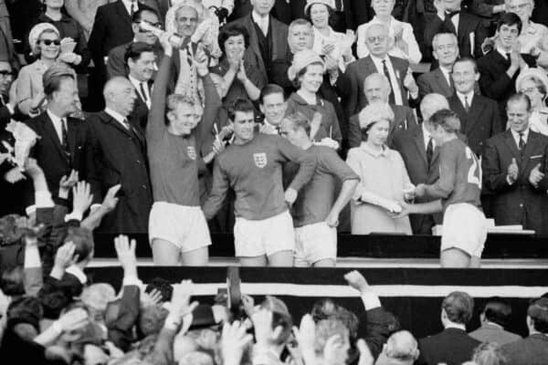 Roger Hunt receives his World Cup winners’ medal from the Queen as England captain Bobby Moore holds the trophy aloft (PA).