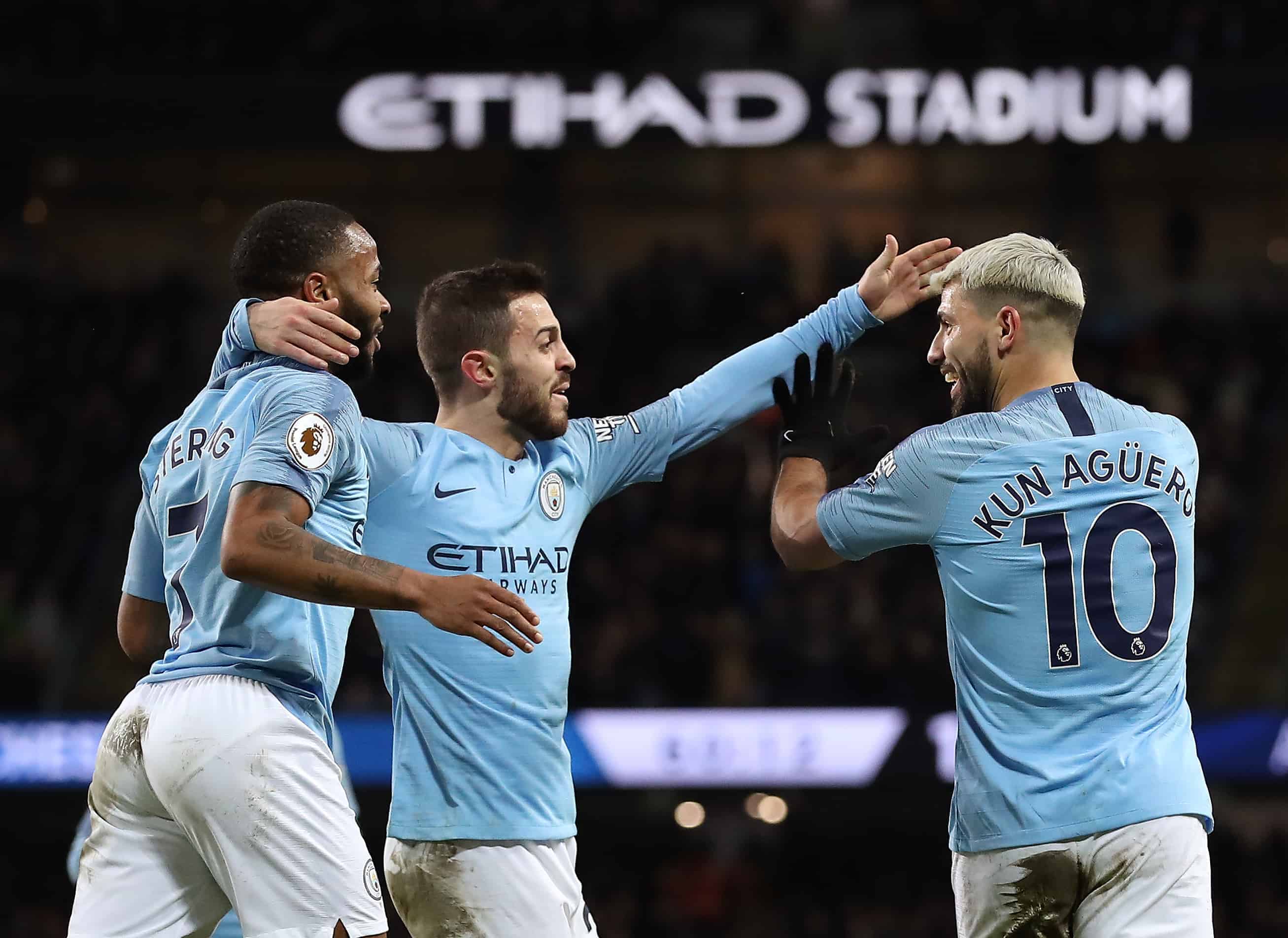 Manchester City's Sergio Aguero (right) celebrates scoring his side's third goal of the game with Raheem Sterling (left) and Mota Bernardo Silva during the Premier League match at the Etihad Stadium, Manchester.