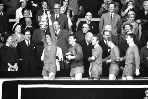 Liverpool footballers pass the Royal box after receiving the FA Cup and their individual medals from the Queen following their 2-1 win over Leeds United in the final at Wembley. Left to right: Yeats, the captain, holding the cup, Lawrence, the goalkeeper, with the plinth, Thompson, Stevenson, Smith and Callaghan, receiving his medal from her Majesty.