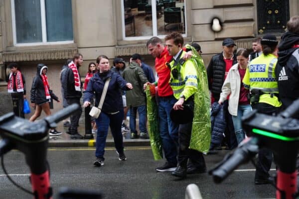 A man leant on a police officer for support (Owen Humphreys/PA)