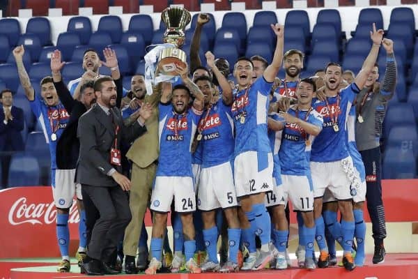 Napoli’s Lorenzo Insigne holds up the trophy (Andrew Medichini/AP)