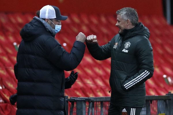 Liverpool manager Jurgen Klopp (left) fist bumps Manchester United manager Ole Gunnar Solskjaer (right) before the Emirates FA Cup fourth round match at Old Trafford, Manchester. Picture date: Sunday January 24, 2021.