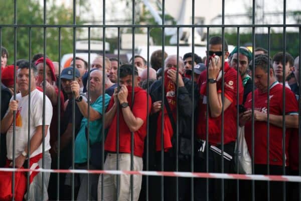 Liverpool fans cover their mouths and noses as they queue to gain entry to the Stade de France (Peter Byrne)