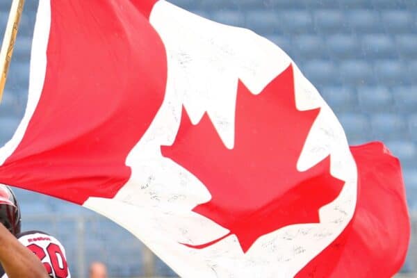 11.07.2011, UPC Arena, Graz, AUT, American Football WM 2011, Group B, Canada (CAN) vs Austria (AUT), im Bild Sammy Okpro (Canada, #20, DB) with the canadian flag // during the American Football World Championship 2011 Group B game, Canada vs Austria, at UPC Arena, Graz, 2011-07-11, EXPA Pictures © 2011, PhotoCredit: EXPA/ T. Haumer